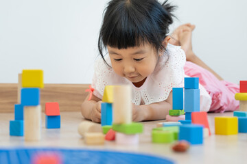 Happy Asian child playing and learning toy blocks. children are very happy and excited at home....