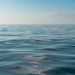 Obraz premium Calm ocean waves in serene blue tones with soft natural lighting for tranquil seascape background