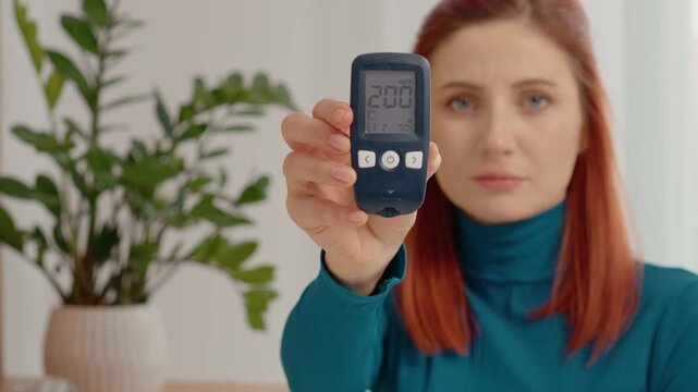 A woman holds a glucometer with a reading of 200 mg dL, showing a high blood sugar level. She emphasizes the importance of monitoring glucose levels regularly.