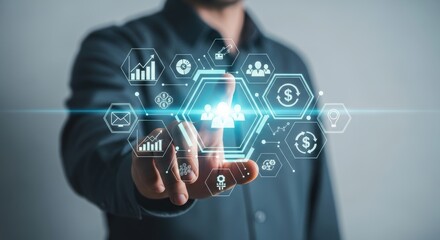 Man selecting teamwork icon on futuristic digital interface showing finance and data metrics