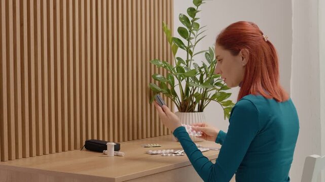 A woman takes a blood sugar test and examines the reading. She looks over at her medication on the table while making a decision about her health.