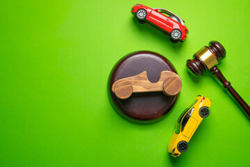 Judge gavel and car on the green background.