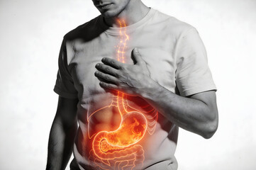 Man experiencing burning stomach and acid reflux with glowing esophagus representing painful digestive issues and heartburn