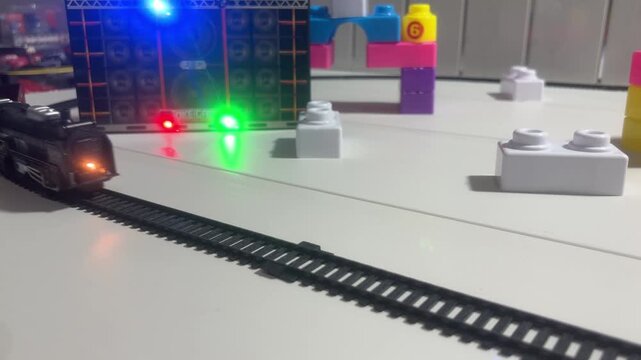 Toy Train Moving Through Colorful Track with Blocks and Play Structures