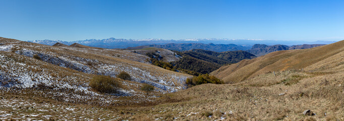 Panoramic view of the Main Caucasian Range and foothills with grassy slopes
