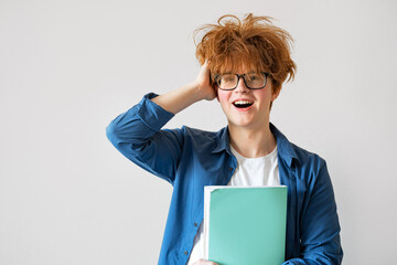 Student boy with messy red hair very happy, surprised and excited