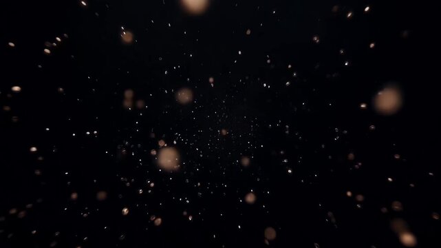 Abstract explosion of golden glowing particles and dust motes in darkness, suggesting celebration, magic, or a cosmic event
