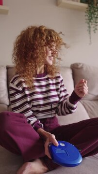 Nostalgic young woman listening to music on a portable cd player