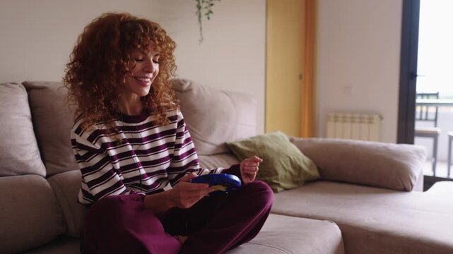 Nostalgic redhead woman listening music on a portable cd player