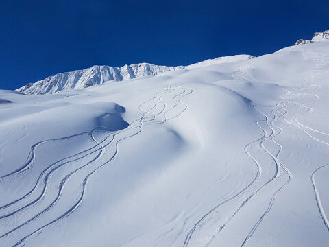 DRONE: Flying above snowboarding and ski tracks left in the deep powder snow.
