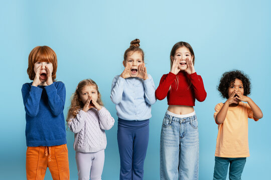 Diverse children shouting and calling out news against a bright blue background