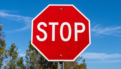 Obraz premium Vibrant Red Stop Sign Against a Bright Blue Sky, Symbolizing Mandatory Halt and Traffic Safety Regulation