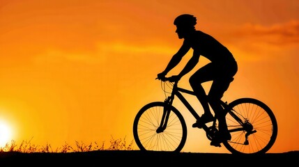 Obraz premium Silhouette of a person riding a bicycle against a vibrant orange sunset