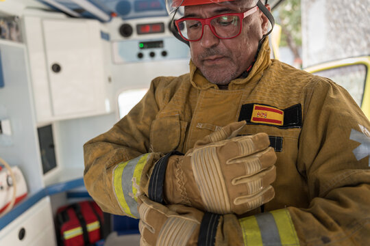 Firefighter wearing protective gear getting ready for rescue operation