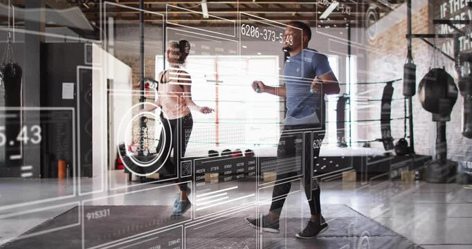 Man and woman starting jump rope routine training in fitness studio, HUD overlay passing foreground