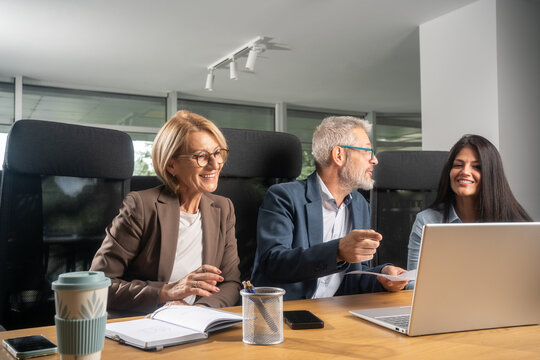 Casual meeting of smiling diverse business team analyzing financial data - Powered by Adobe
