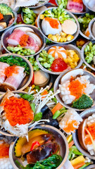 A variety of Dim Sum delicacies in small bowls, showcasing diverse ingredients and colors. An overhead shot displays multiple, appetizing options for food lovers