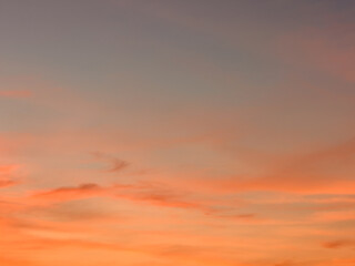 A captivating sunset painted across the sky, displaying a beautiful array of orange and gray hues
