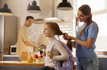 Happy School Morning: Mom Helps Daughter with Backpack