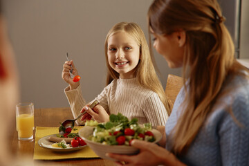 Smiling Girl Enjoying Healthy Lunch with Her Mom at Home