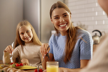 Mother and Daughter Smiling During Healthy Lunch Together