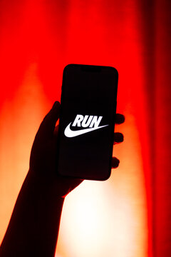 Kaliningrad, Russia - 12.11.2025. Smartphone screen in woman hands displaying logotype of popular application for sport activity Nike Running. Run, health, steps, sport, activity concept