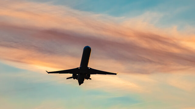 Summer sunset or sundowner view with airplane silhouettes near Munich airport, MUC, Freising, Bavaria, Germany