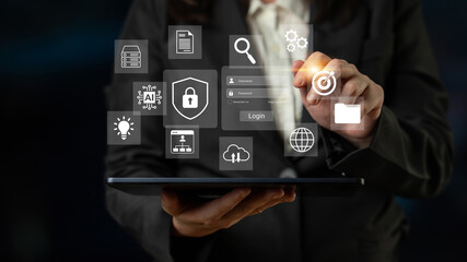 A business professional engages with a tablet, displaying various digital security and data analytics icons, illustrating modern technology in action. Gantry