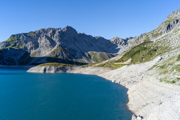 Obraz premium Hiking to Schesaplana with view at Lunersee lake in Ratikon mountain range, Vorarlberg, Austria during a clear day