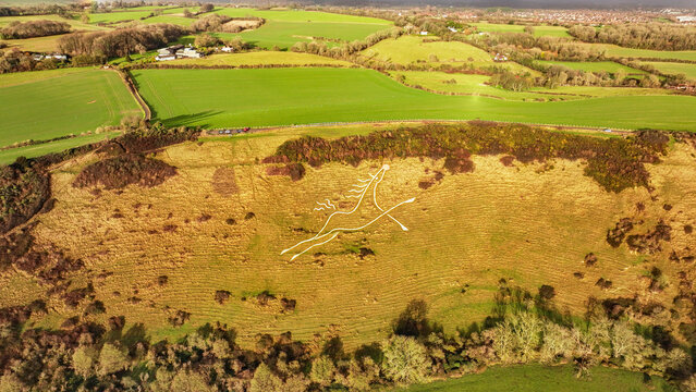 Aerial view of the Folkestone White Horse, a striking chalk figure carved into the hillside, contrasting with the verdant fields, Folkestone, England, United Kingdom.