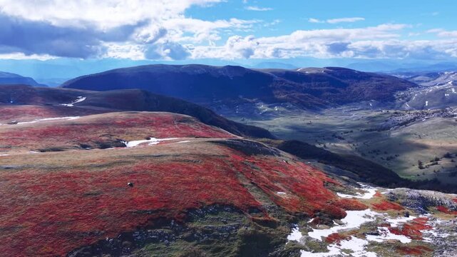 Vibrant red autumn vegetation covering high altitude ountain plateau
