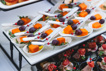 Decorated catering table buffet, banquet with variety of different gourmet exquisite food snacks...