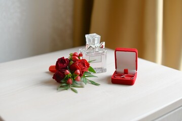wedding accessories. perfume boutonniere and rings