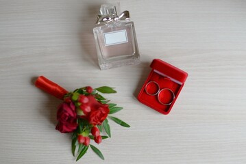 wedding accessories. perfume boutonniere and rings