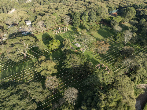 Aerial view of a lush green space interspersed with rows of seating, a small building, and tall trees, Nairobi, Nairobi, Kenya.