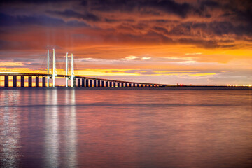 Fototapeta premium Modern bridge structure for cars and trains in Europe at sunset, Øresund Strait, Malmö, Sweden, Scandinavia.