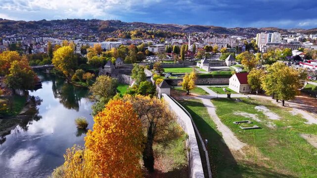 Aerial view of historic stone fortress walls and rive in autumn city