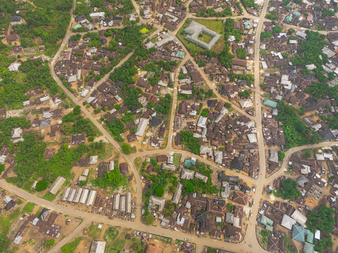 Aerial view of a dense settlement with buildings of varying sizes interspersed with patches of green vegetation, Egbeda, Rivers, Nigeria.