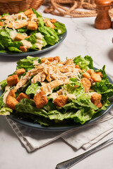 Caesar salad with shredded chicken, croutons and parmesan