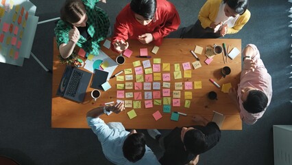 Top view of creative team giving high five to celebrate successful idea or increasing sales. Group...