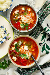 Stuffed Bell Pepper Soup in a ceramic bowl on a table.  .style hugge
