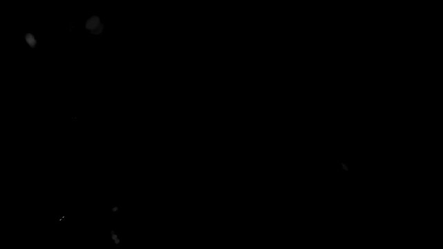 Blurred motion overlay of blowing dirt. Real dust particles floating in air isolated on black background. 