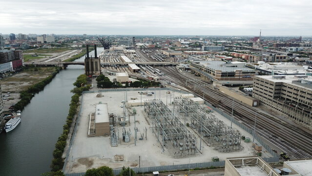 Aerial view of the intricate network of train tracks and power infrastructure sprawling under a cloudy sky, Juno Beach, Florida, United States.