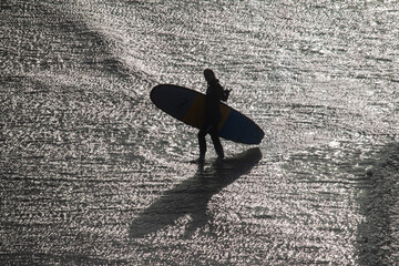 surfer at sunset silhouette of a girl in the UK