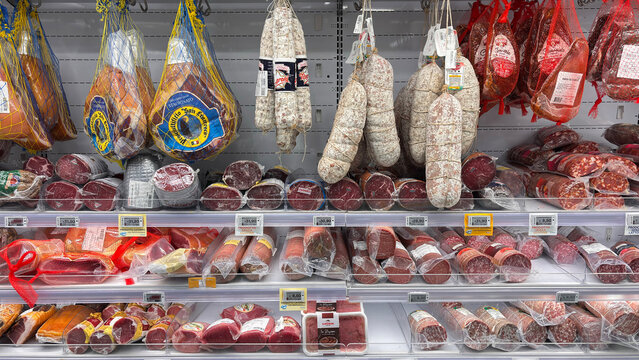 various types of cured meats arranged on the supermarket shelf. Udine, Italy. January 21, 2026
