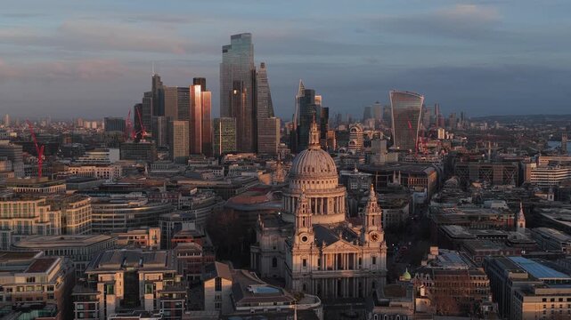 Aerial view of St. Paul's Cathedral and the London skyline bathed in soft light, showcasing a blend of historic architecture and modern skyscrapers, London, United Kingdom.