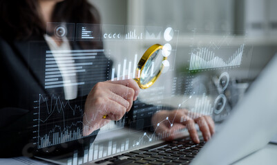 A business professional focuses on data trends using a magnifying glass, highlighting the importance of analysis in modern decision-making and strategy development. Scalp
