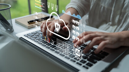 A person interacts with a laptop in a modern workspace, showcasing cloud security elements and data visualizations, highlighting the fusion of technology and efficiency. Gantry