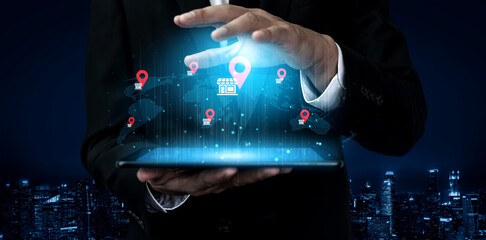 A business professional showcases a glowing tablet with interactive data visuals, representing global store locations against a dark city backdrop, emphasizing modern technology and strategy. Gantry