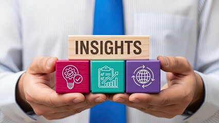 Man holding wooden blocks displaying "INSIGHTS" on top, with colorful blocks below featuring icons for innovative ideas, data analysis, and global strategy, representing business intelligence.